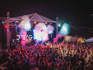 Free Lively outdoor music festival with vibrant lights, crowd energy, and a dynamic performance. Stock Photo